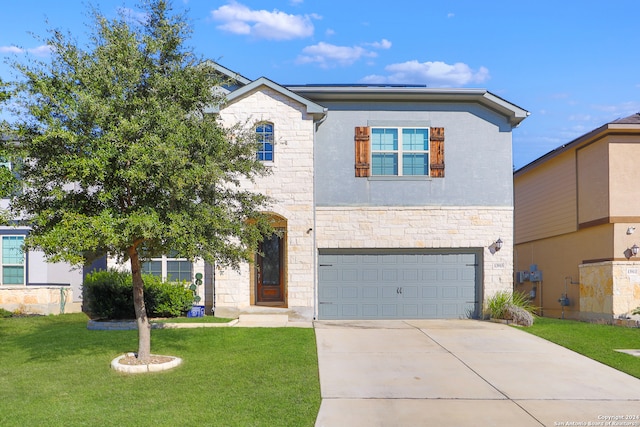 view of front of property with a front lawn and a garage