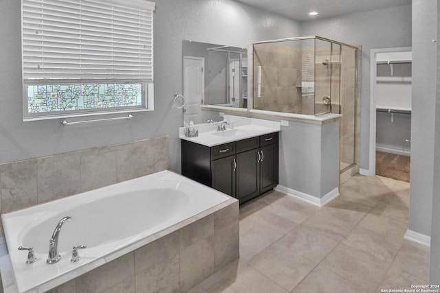 bathroom with tile patterned floors, vanity, and plus walk in shower