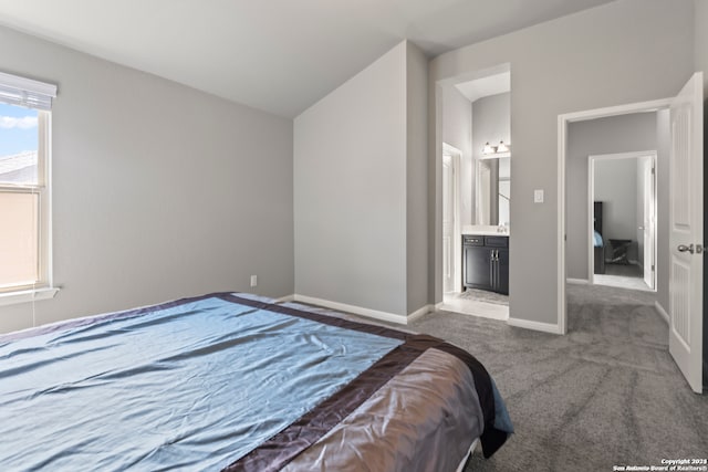 bedroom with carpet and connected bathroom