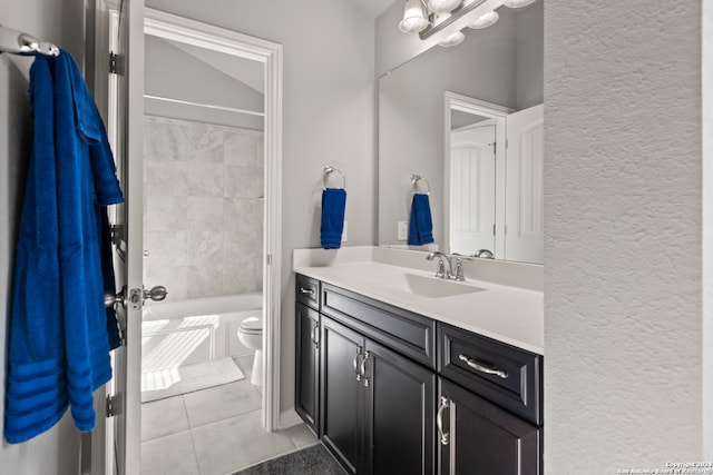 full bathroom with tile patterned flooring, vanity, toilet, and tiled shower / bath combo