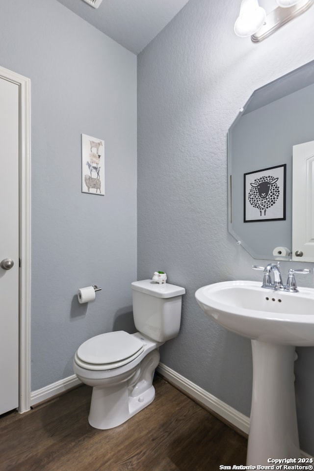 bathroom with sink, hardwood / wood-style floors, and toilet