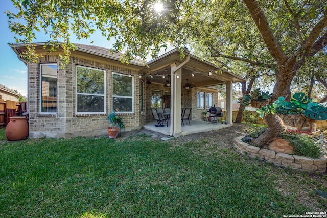 back of house featuring a yard, a patio, and ceiling fan