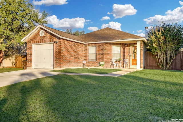 single story home featuring covered porch, a garage, and a front lawn