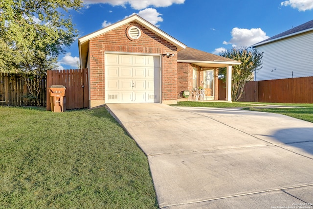 view of front of home featuring a front yard and a garage