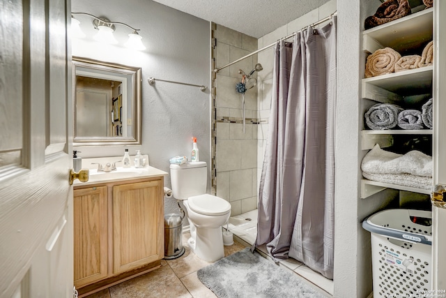 bathroom with vanity, tile patterned flooring, toilet, a textured ceiling, and curtained shower