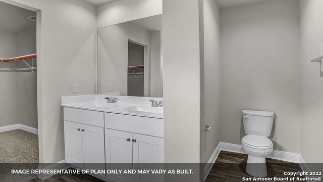 bathroom with vanity, toilet, and wood-type flooring