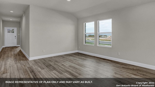 empty room featuring lofted ceiling and wood-type flooring