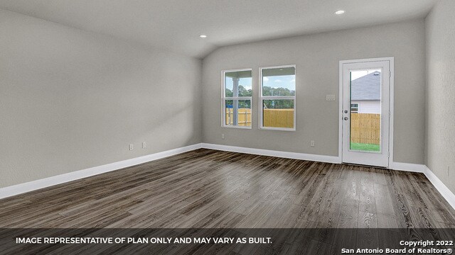 unfurnished room featuring dark wood-type flooring and vaulted ceiling