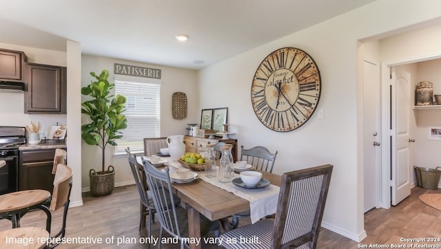 dining space with light wood-type flooring