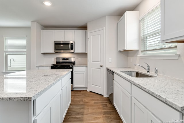 1205 Pacific Monarch, San Antonio, TX 78253 - kitchen featuring appliances with stainless steel finishes, a sink, white cabinetry, wood finished floors, and recessed lighting