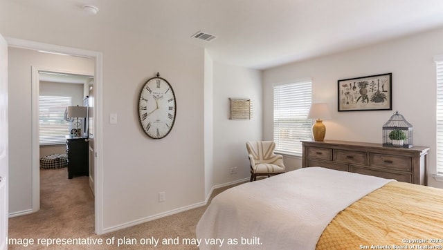 bedroom featuring light carpet