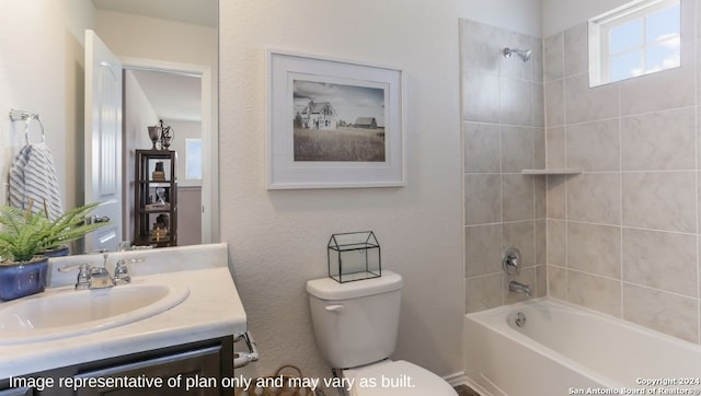 full bathroom with vanity, tiled shower / bath combo, and toilet