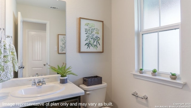 bathroom with vanity and toilet