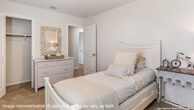 bedroom featuring light colored carpet and a closet