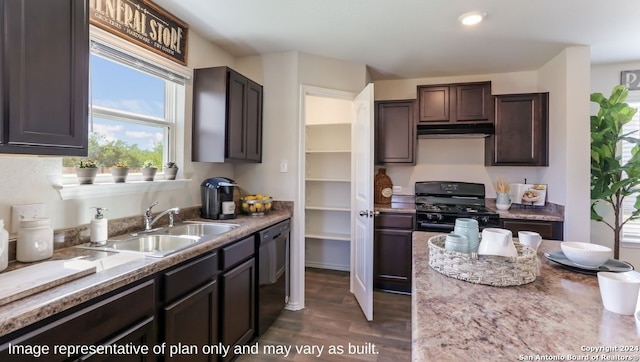 kitchen featuring dark brown cabinetry, sink, light stone counters, dark hardwood / wood-style floors, and black appliances