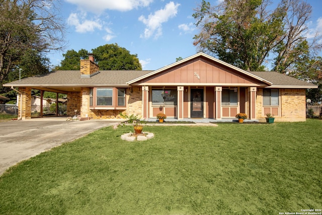 view of front of property with a front yard, a carport, and covered porch