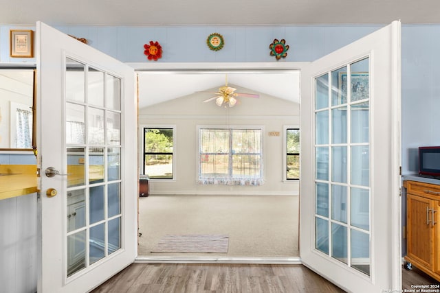 entryway featuring ceiling fan, french doors, wood-type flooring, and lofted ceiling