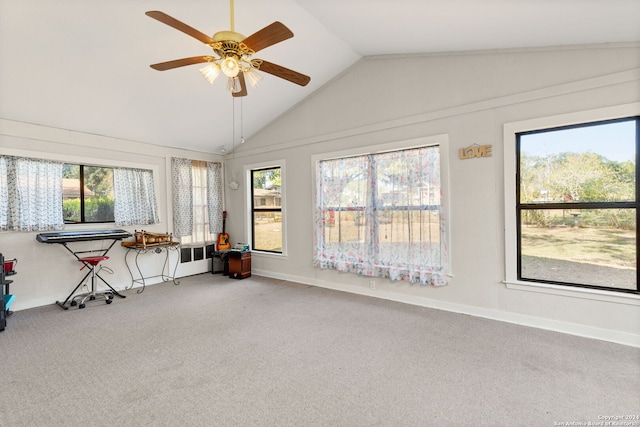 sunroom with ceiling fan, plenty of natural light, and vaulted ceiling