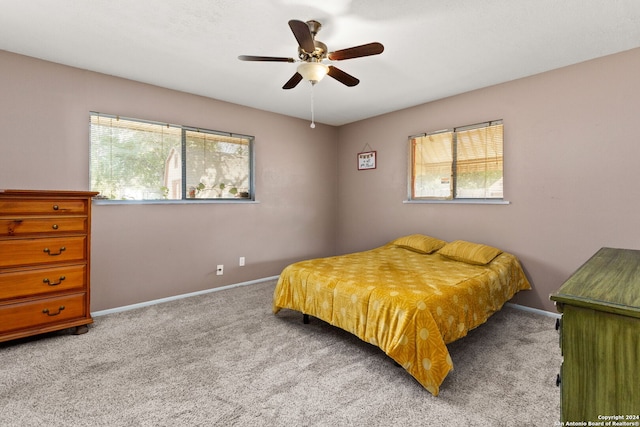 bedroom with ceiling fan and light colored carpet