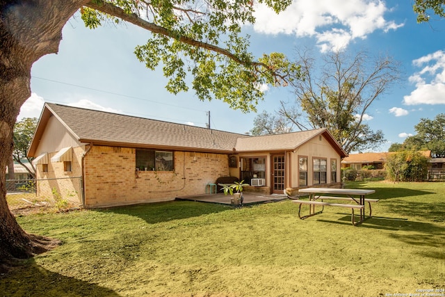 back of property featuring a patio area and a yard