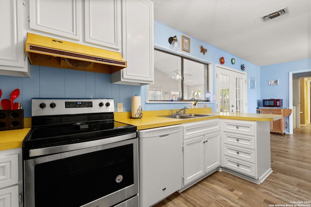 kitchen featuring white dishwasher, stainless steel electric range, light wood-type flooring, and sink