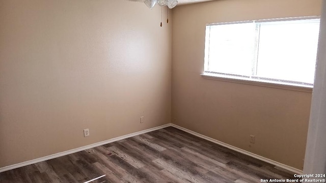 empty room with dark wood-type flooring