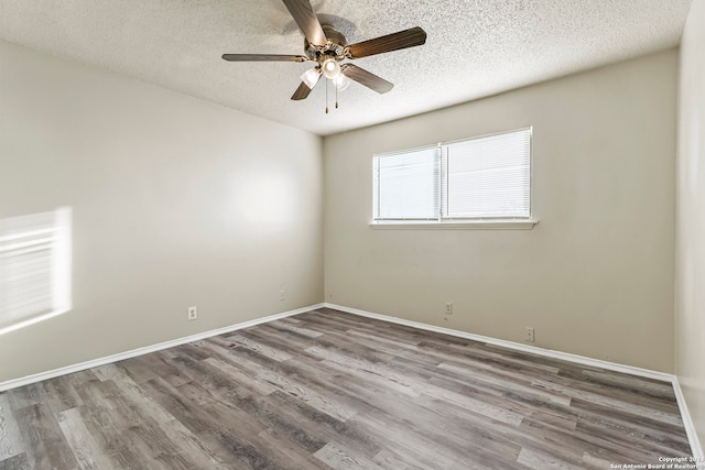 empty room featuring hardwood / wood-style flooring, ceiling fan, and a textured ceiling