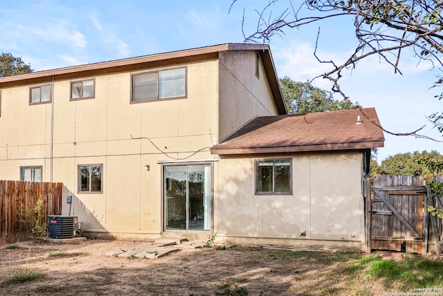 back of property with central AC