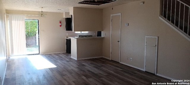 kitchen with decorative light fixtures, dark hardwood / wood-style flooring, and a textured ceiling