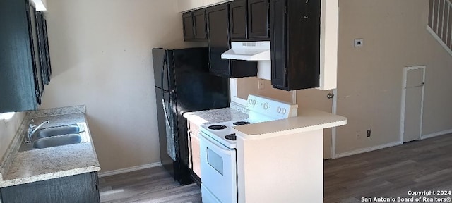 kitchen with black fridge, extractor fan, sink, electric stove, and wood-type flooring