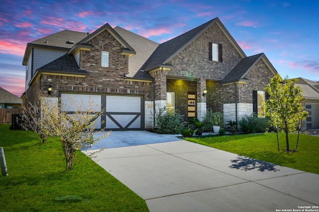 view of front of house featuring a lawn and a garage