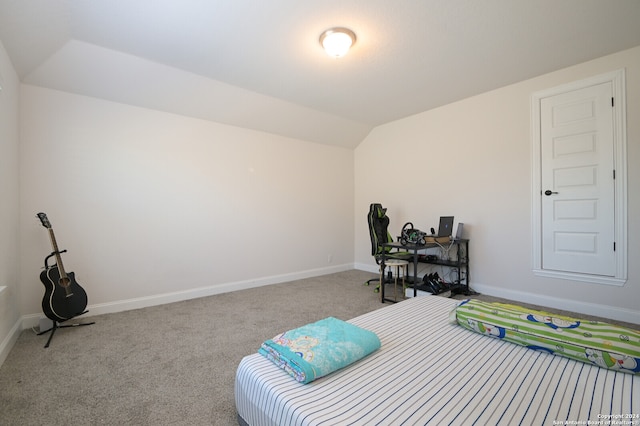 bedroom with light carpet and lofted ceiling