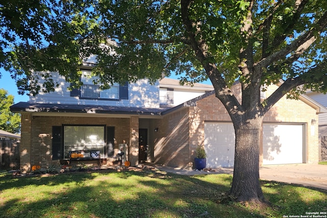 view of front of house with a front yard and a garage