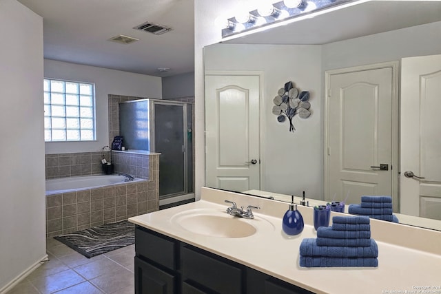 bathroom featuring tile patterned flooring, vanity, and independent shower and bath