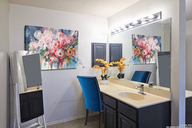 bathroom with tile patterned flooring, vanity, and a textured ceiling