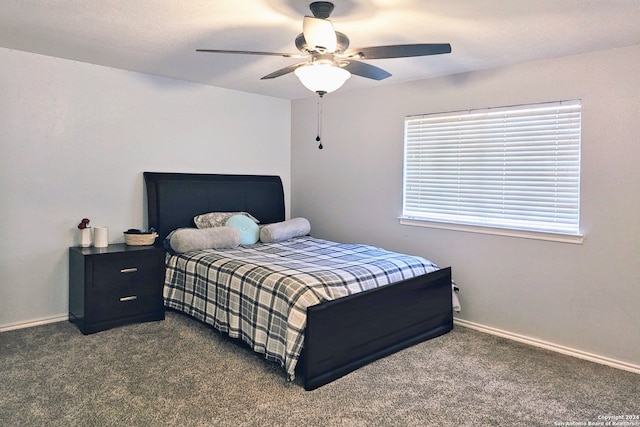 bedroom featuring multiple windows, ceiling fan, and dark colored carpet