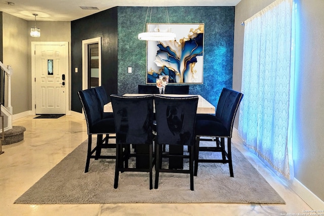 dining area featuring an inviting chandelier