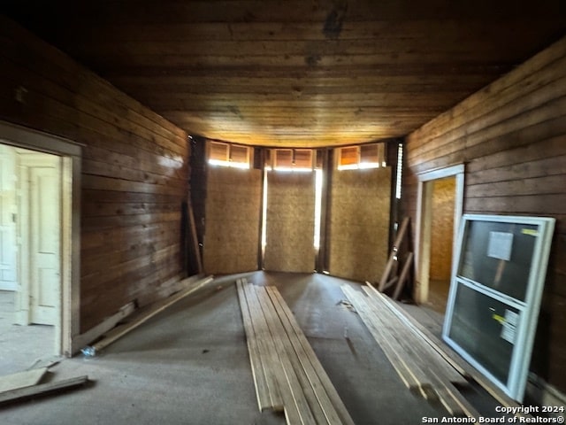 miscellaneous room featuring wooden walls and wooden ceiling