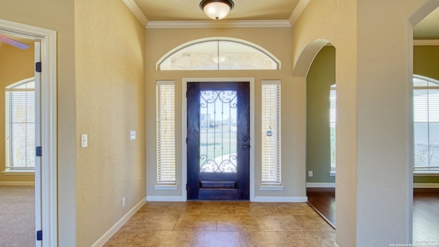 entryway with light wood-type flooring and ornamental molding