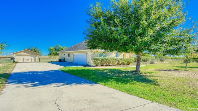 view of front of home featuring a garage and a front lawn