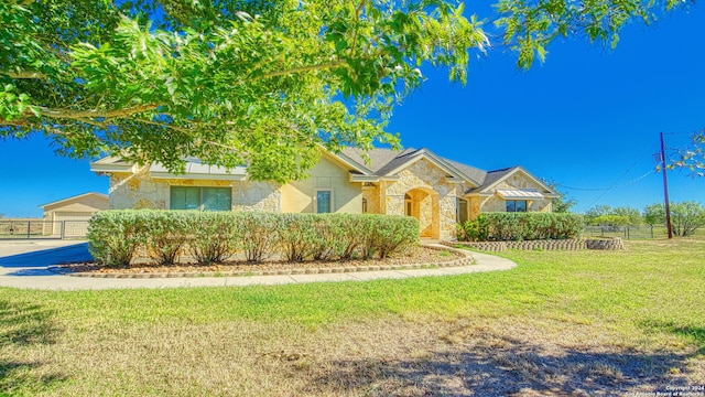 view of front of home featuring a garage and a front lawn