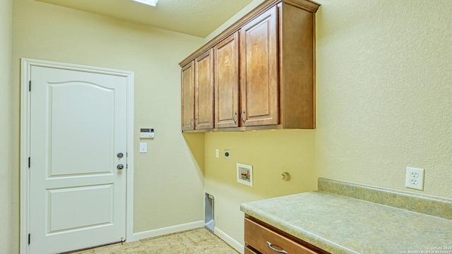 washroom featuring electric dryer hookup, hookup for a washing machine, and cabinets