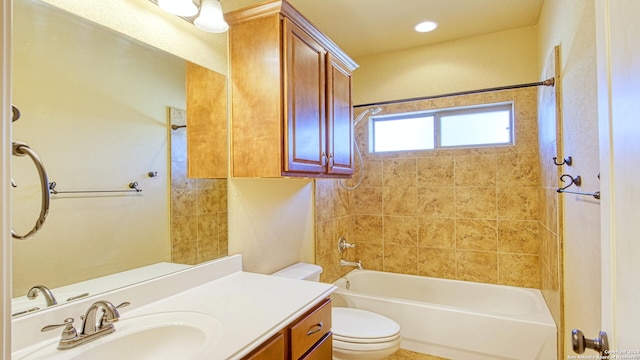 full bathroom featuring vanity, tiled shower / bath combo, and toilet