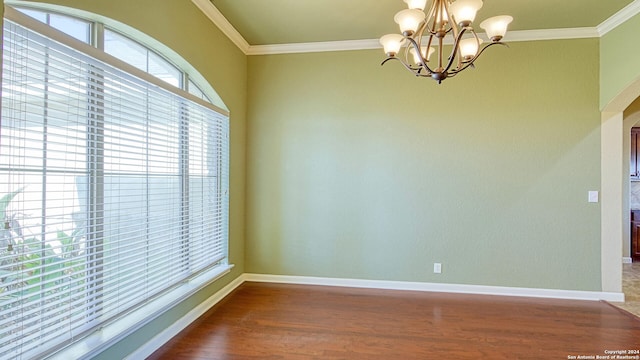 unfurnished room with a chandelier, hardwood / wood-style floors, and ornamental molding