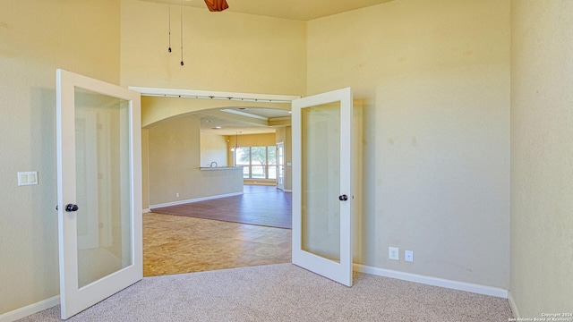 carpeted empty room with french doors