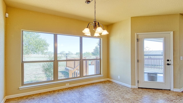 interior space with light tile patterned floors and a chandelier