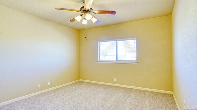 spare room featuring carpet flooring and ceiling fan