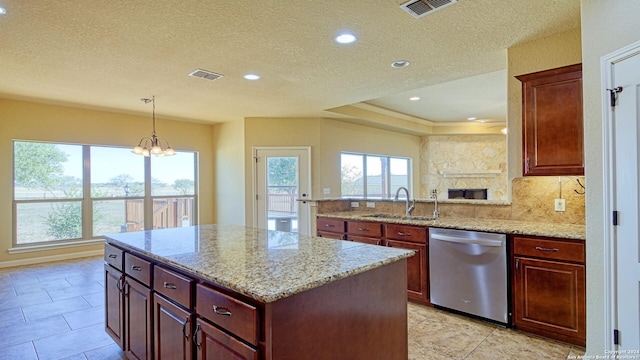 kitchen with sink, hanging light fixtures, stainless steel dishwasher, a notable chandelier, and a kitchen island