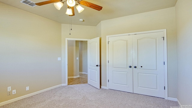 unfurnished bedroom with a closet, ceiling fan, and light colored carpet