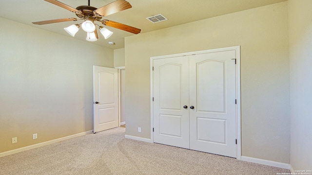 unfurnished bedroom featuring a closet, ceiling fan, and light colored carpet